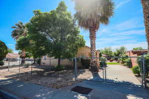 View of front of house featuring a gate, stucco siding, and a fenced front yard