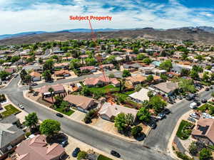 Aerial perspective of suburban area featuring a mountainous background