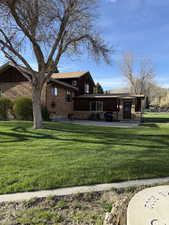 View of home's exterior featuring a lawn, board and batten siding, and brick siding