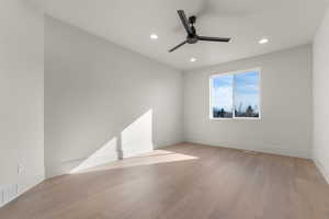Spare room with light wood-style floors, recessed lighting, and ceiling fan