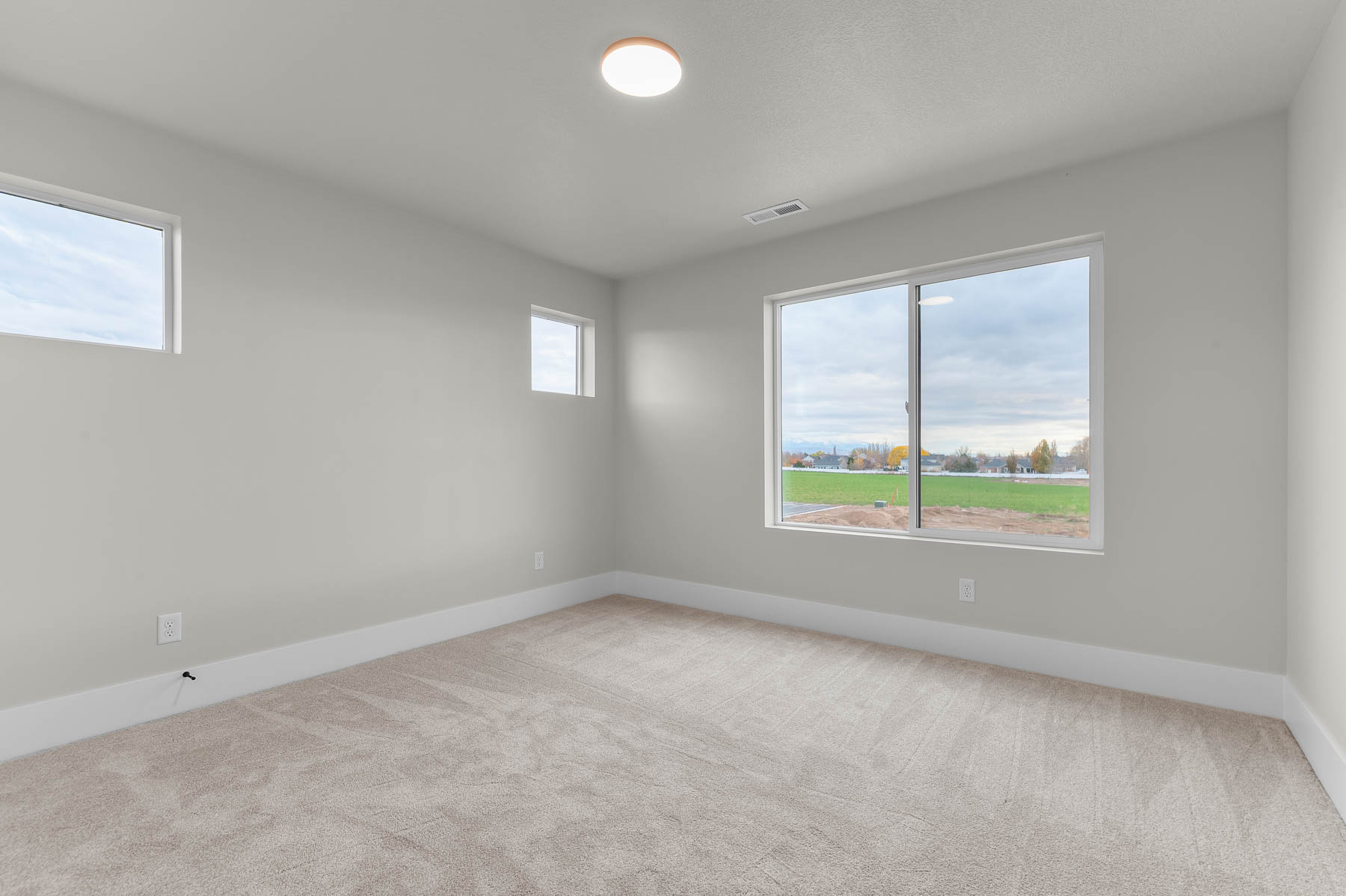 Spare room with light carpet and plenty of natural light