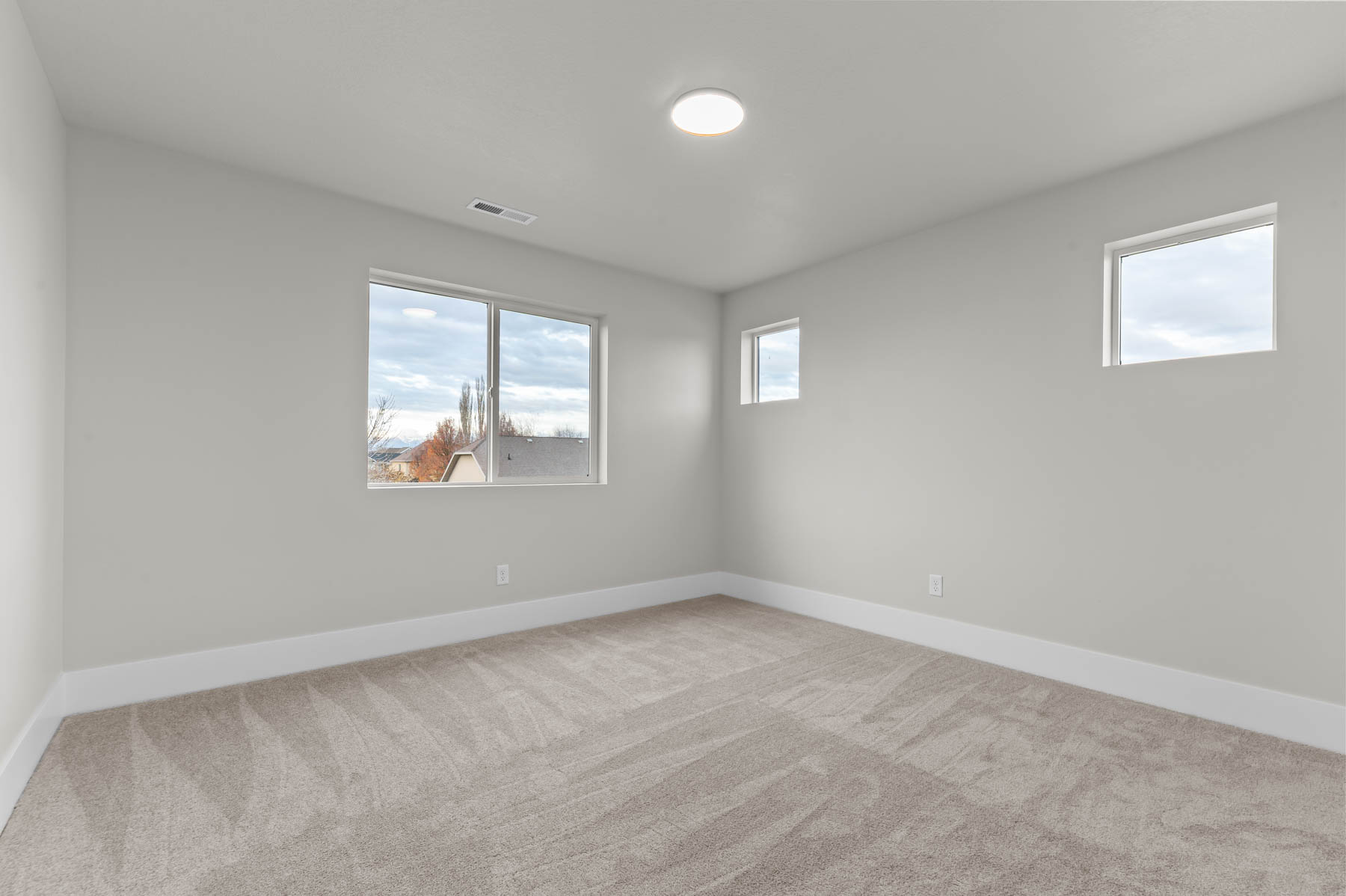 Spare room featuring light carpet