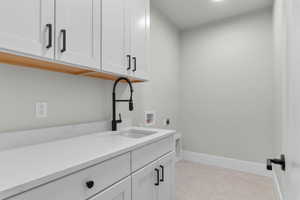 Laundry room featuring cabinet space, hookup for an electric dryer, and washer hookup