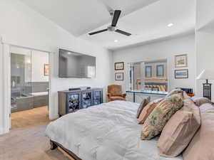 Carpeted bedroom with ceiling fan, recessed lighting, lofted ceiling, and connected bathroom