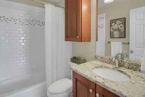 Full bathroom featuring vanity and shower / bath combination with curtain