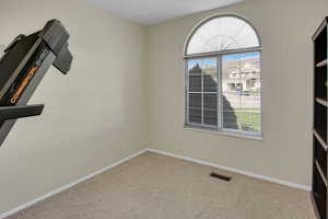 Empty room with baseboards and light carpet