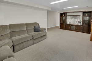 Living room featuring light carpet and baseboards
