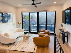 Sitting room featuring light wood finished floors, ceiling fan, plenty of natural light, and recessed lighting