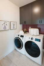 Laundry area with cabinet space and washer and dryer