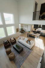 Living room featuring a high ceiling and light wood finished floors