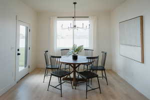 Dining room featuring light wood finished floors and suspended lighting