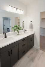 Ensuite bathroom with double vanity and a spacious closet