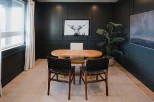 Dining room with a decorative wall and light wood-type flooring