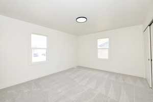 Empty room with light colored carpet
