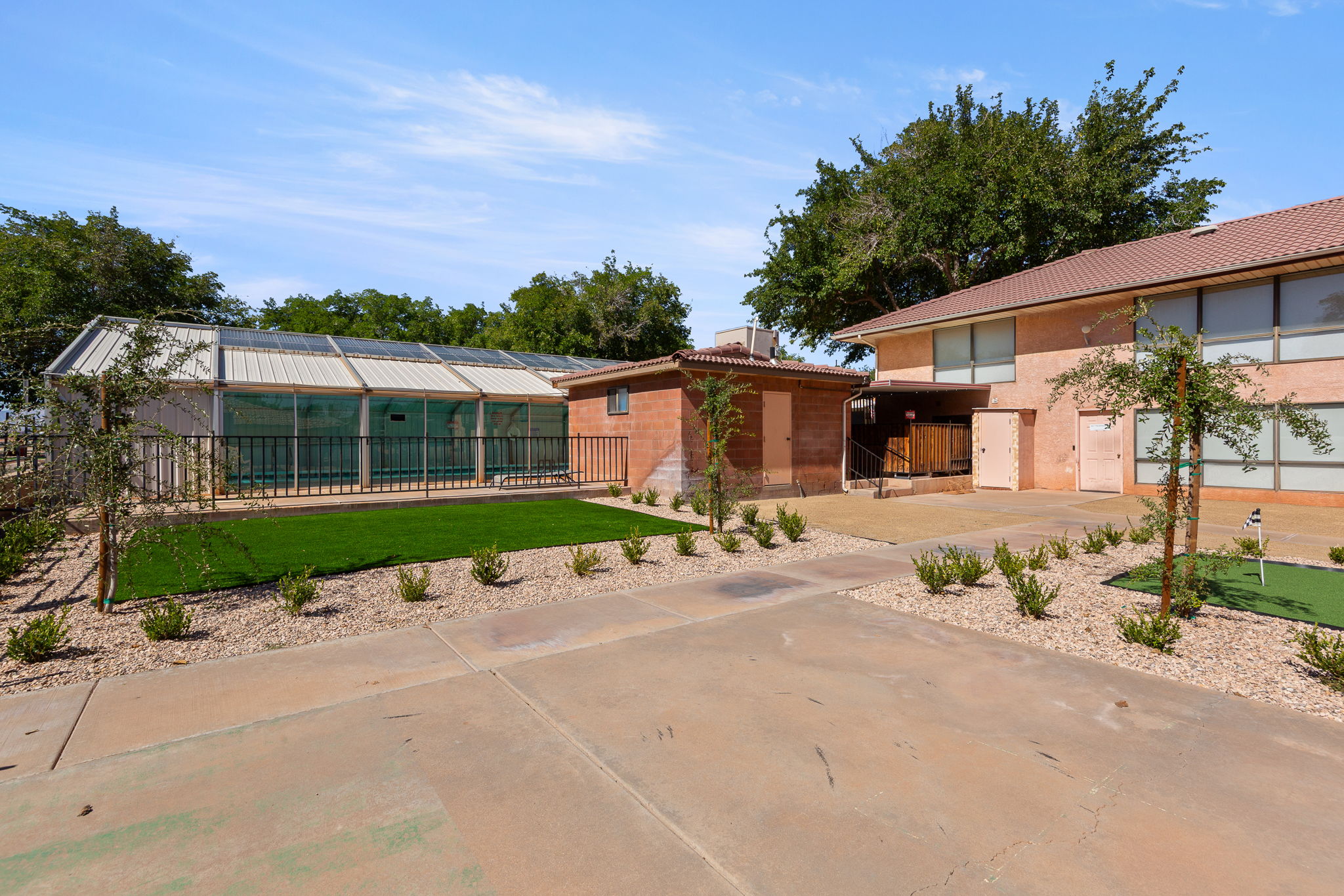 View of front facade with a putting area, a tiled roof, and a chimney