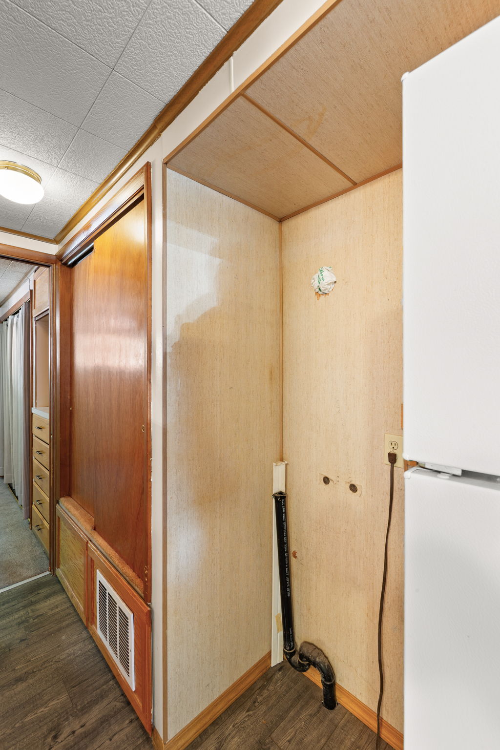 Corridor featuring dark wood finished floors