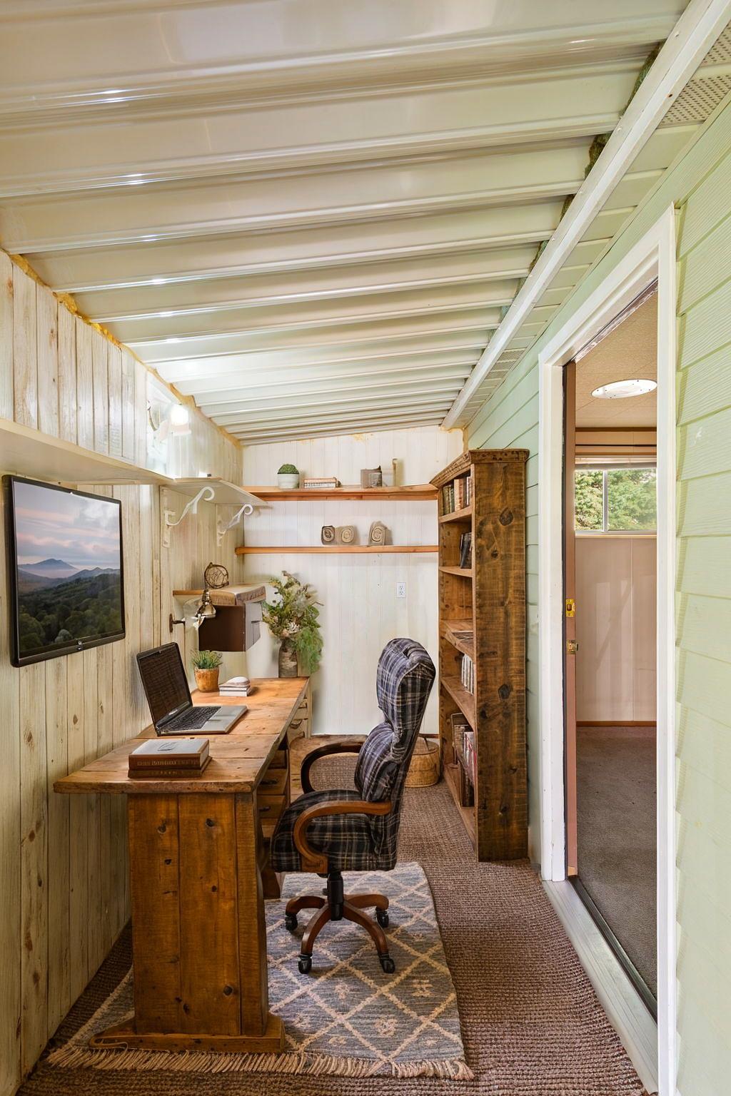 Office space featuring wooden walls and carpet floors