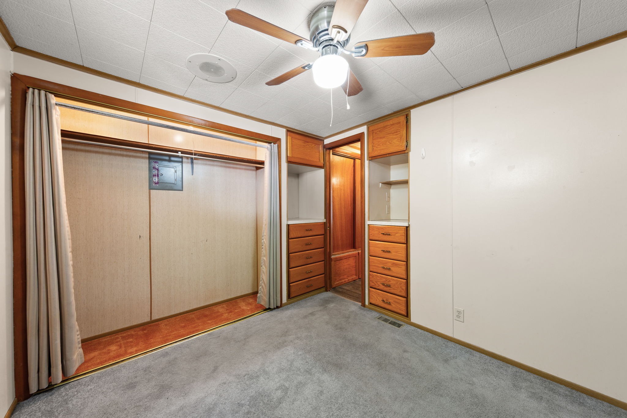 Unfurnished bedroom featuring ceiling fan, light carpet, a closet, and crown molding