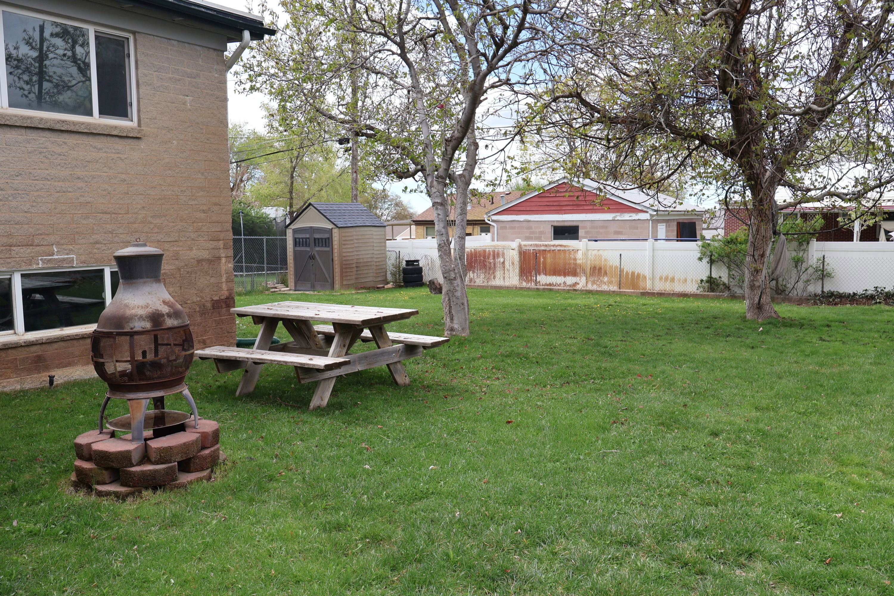 Fenced backyard with a shed