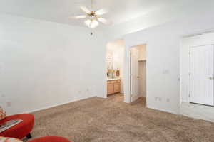Sitting room featuring light colored carpet and a ceiling fan