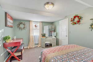 Bedroom featuring carpet and baseboards