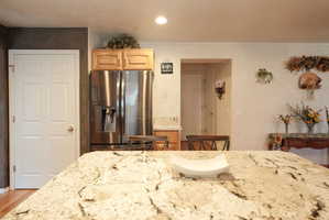 Spacious kitchen island featuring a light-toned granite countertop with natural veining