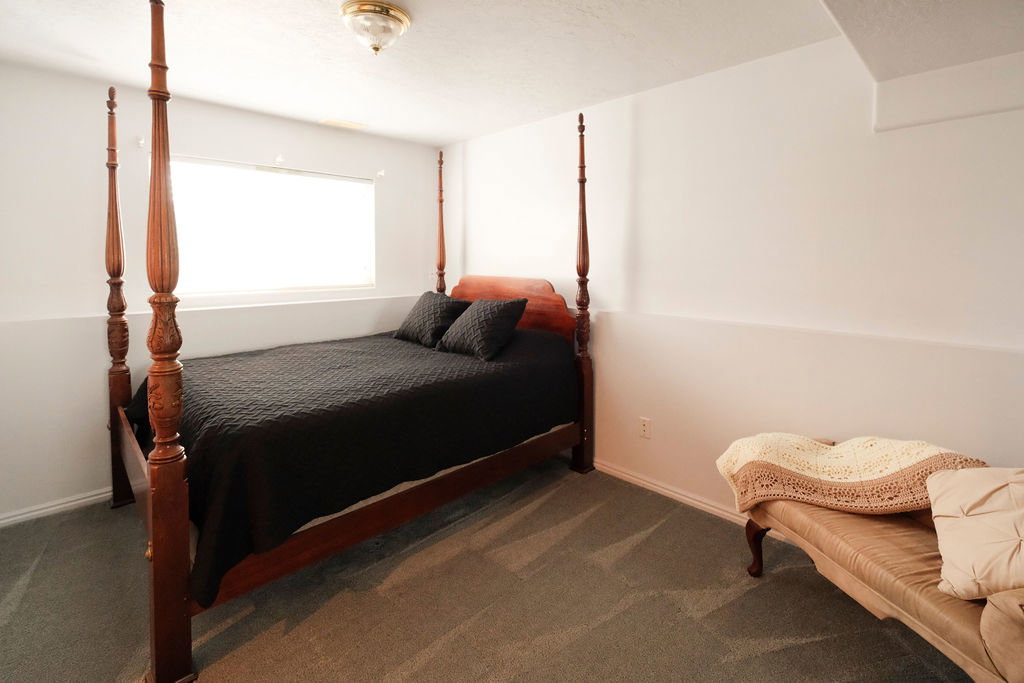 Recessed window with natural light, neutral wall colors, textured carpet flooring, and a flush mount ceiling light fixture