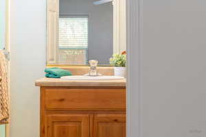 Bathroom featuring vanity and a textured wall