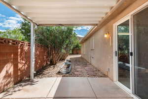 Fenced backyard with a patio area