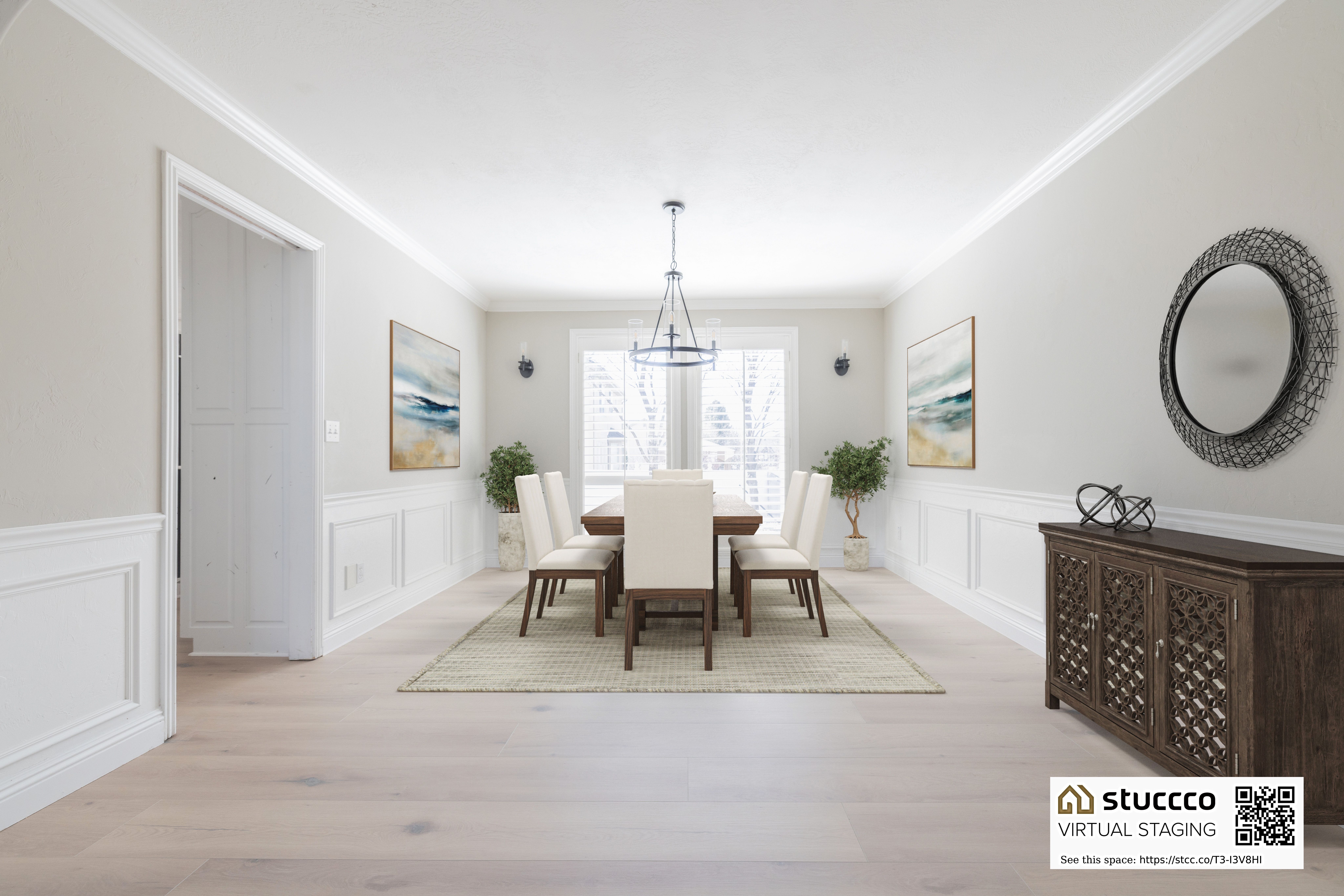 Dining area featuring a decorative wall, light wood-style floors, wainscoting, ornamental molding, and suspended lighting