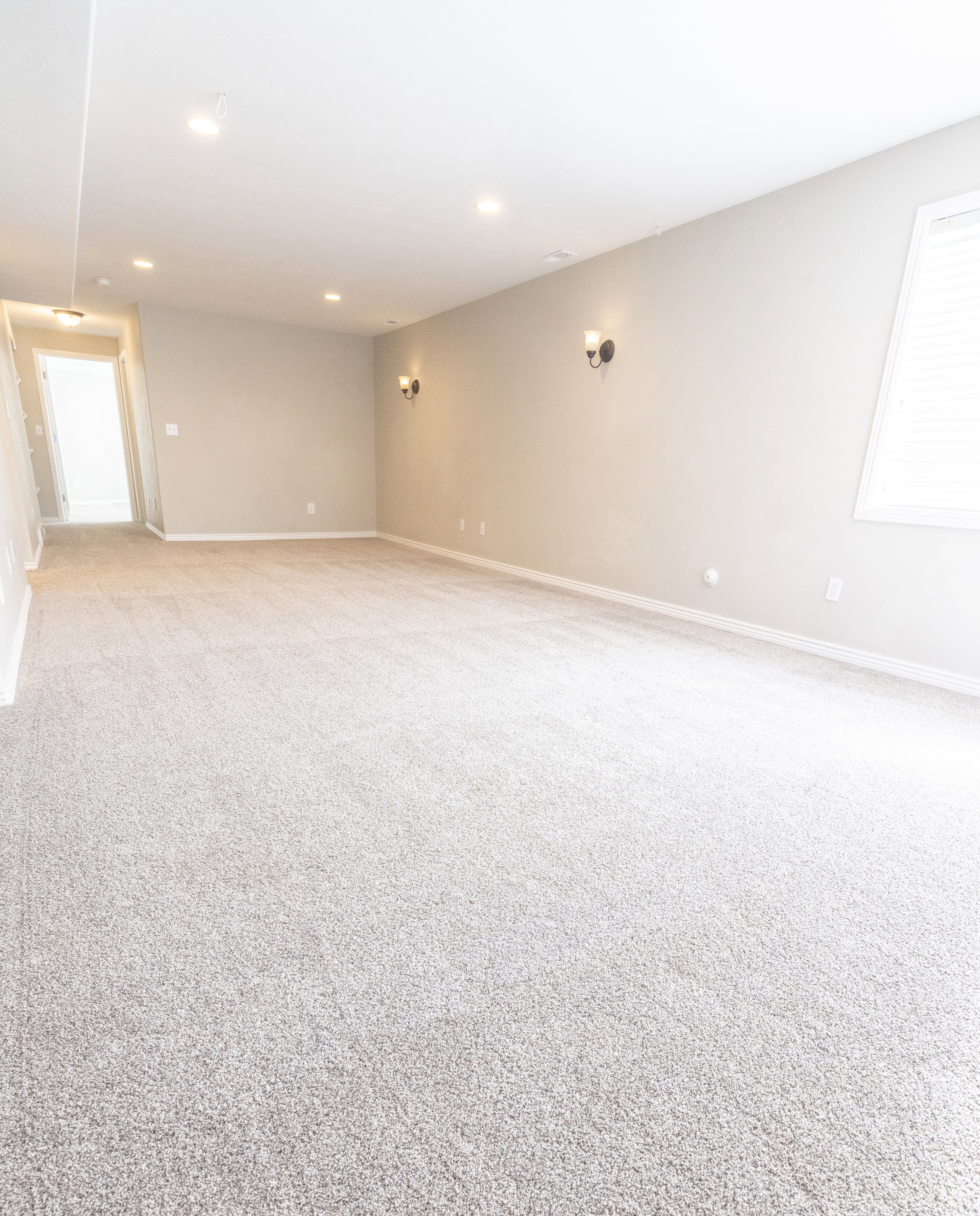 Spare room featuring light colored carpet and recessed lighting