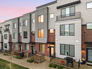Contemporary home featuring stucco siding and brick siding
