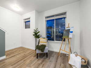 Living area with light wood-type flooring and baseboards