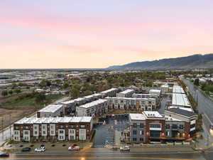 Aerial view at dusk of a view of apartment building / complex and a mountain view