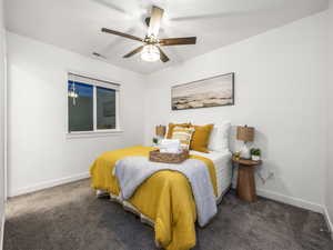 Bedroom with dark colored carpet and a ceiling fan