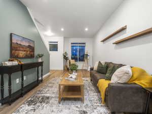 Living area featuring wood finished floors and recessed lighting