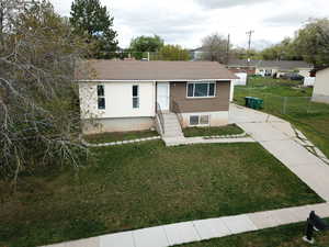 Ranch-style house featuring roof with shingles