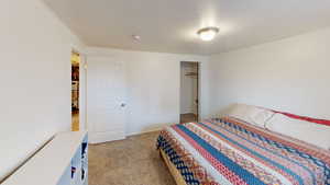 Bedroom featuring light colored carpet and a closet