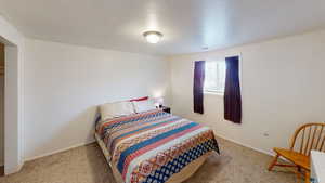 Bedroom with light carpet and baseboards