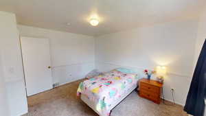 Carpeted bedroom with baseboards