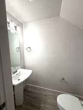 Bathroom with dark wood finished floors and a textured ceiling