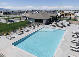 Community pool featuring a patio area and a residential view
