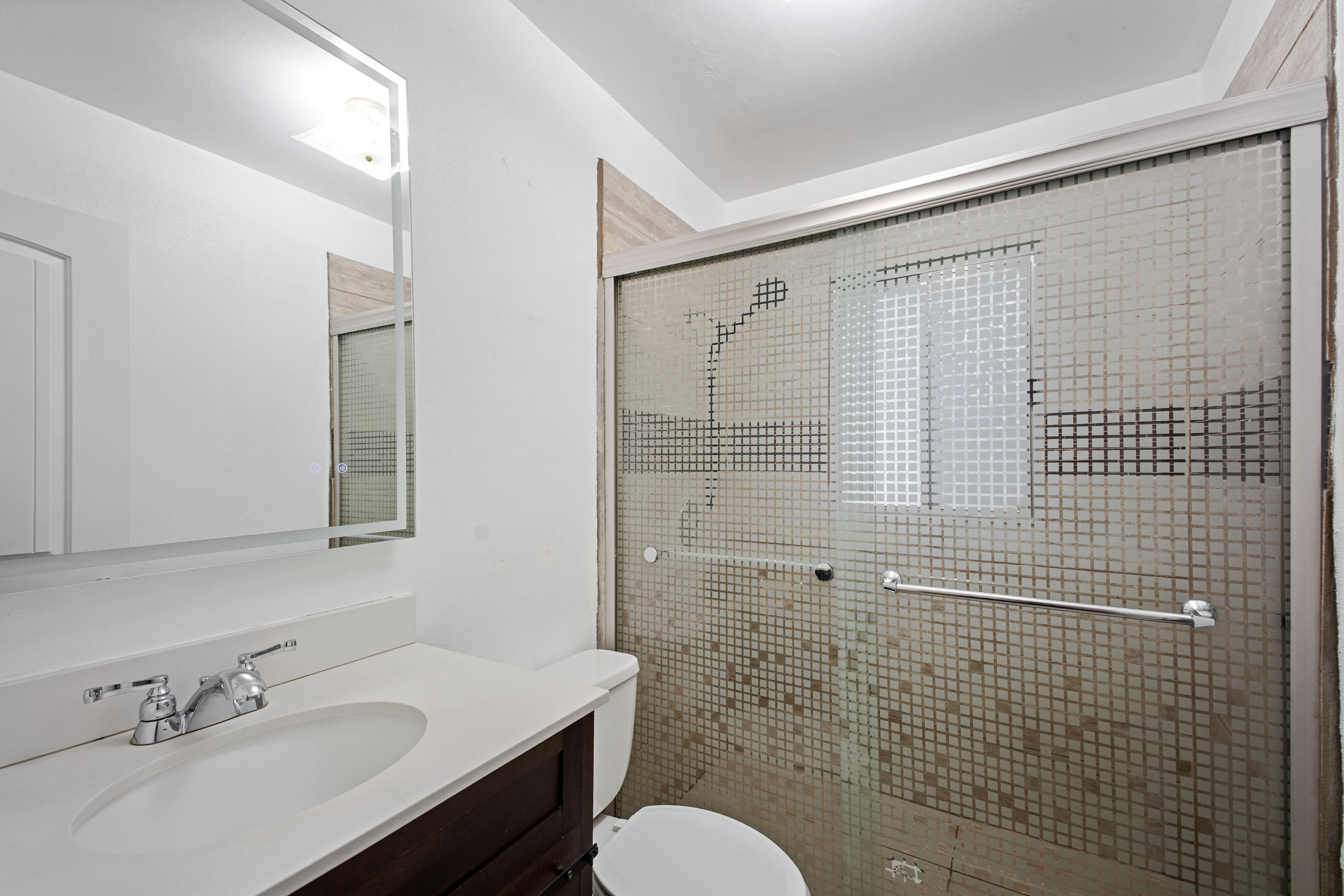 Bathroom with vanity and a stall shower