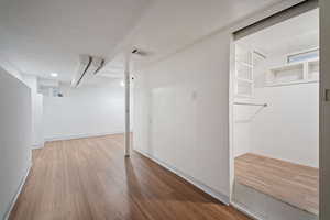 Finished basement featuring light wood finished floors and baseboards