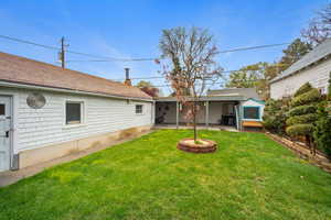 Rear view of property featuring a patio area and yard