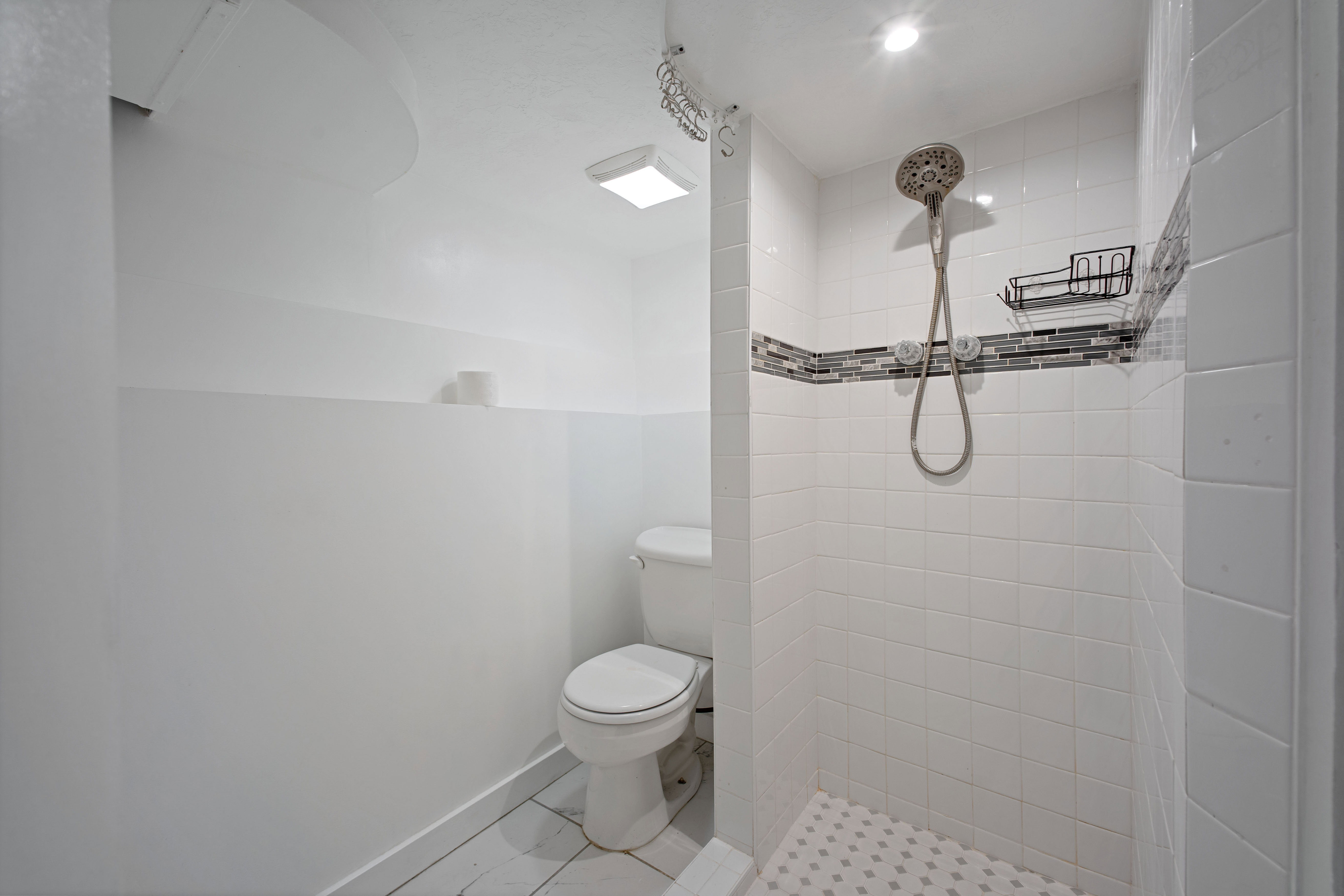 Bathroom with toilet and a shower stall