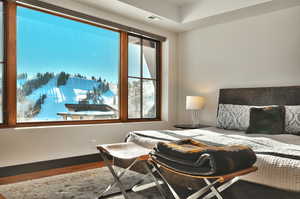 Bedroom featuring baseboards and wood finished floors