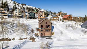 Snowy aerial view featuring a residential view