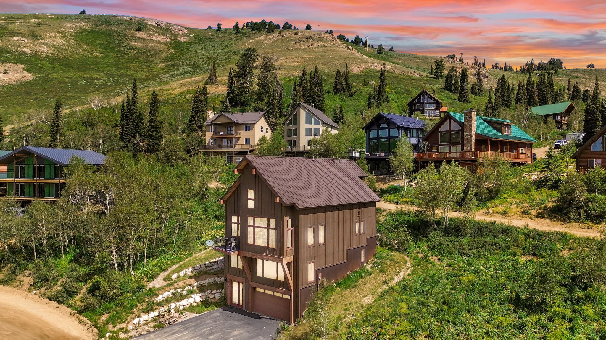 Multi-level brown-sided residence with a brown metal roof