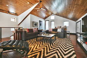 Living area featuring dark wood-style floors, ceiling fan, a high wooden ceiling, and track lighting